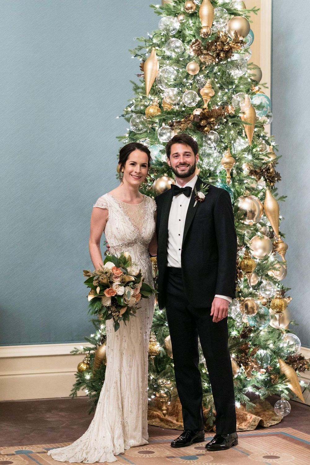 Bride and Groom in Front of Christmas