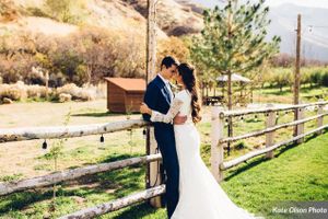 Hoopes Events | Charming Barn Wedding | Quiet Meadow Farms | Mapleton Utah | Couple Embracing by Wooden Fence Charming_Barn_Wedding_Quiet_Meadow_Farms_Mapleton_Utah_Couple_Embracing_Fence.jpg