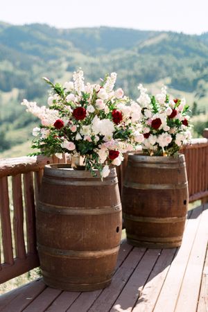 Whiskey Barrel Backdrop with Floral Arrangement Ceremony Details