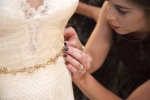 Hoopes Events | McCall and Brad | DeJoria Center | High Star Ranch | Kamas Utah | Bride Putting on Gold Belt McCall_Brad_High_Star_Ranch_Kamas_Utah_Bride_Gold_Belt.jpg