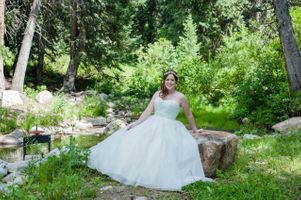 Ashley_Dan_Solitude_Resort_Solitude_Utah_Bride_Seating_on_Rock_Near_Mountain_Stream.jpg