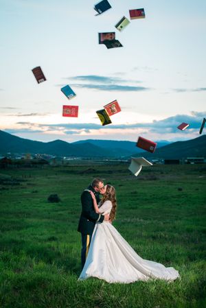 Hoopes Events | Katelyn and David | Park City Utah | Books Fly in the Air as the Couple Kisses at Sunset Katelyn_David_Park_City_Utah_Sunset_Kiss_Flying_Books.jpg