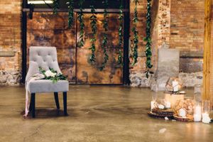 Hoopes Events | Modern Industrial Shoot | The Historic Startup Building | Provo Utah | Chair with Greenery Backdrop and Candles Modern_Industrial_Wedding_Shoot_The_Historic_Startup_Building_Provo_Utah_Chair_Greenery_Backdrop_Candles.jpg