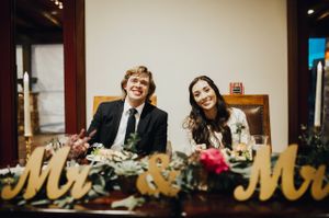 Bride and Groom Sit at Mr. and Mrs. Sweetheart Table Reception