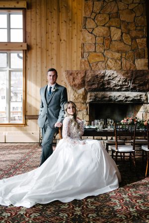 Hoopes Events | Rocky Mountain Bride | Winter Elopement | Deer Valley | Empire Lodge | Park City Utah | Classic Pose of Groom Standing Behind Bride | Bride Seated at Table Rocky_Mountain_Bride_Winter_Elopement_Deer_Valley_Empire_Lodge_Deer_Valley_Resort_Park_City_Utah_Classic_Pose_Groom_Standing_Bridge_Sitting.jpg
