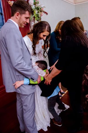 Hoopes Events | Shauna and Blake | Northampton House | American Fork Utah | Young Child Gives the Radiant Couple a Hug Shauna_Blake_Northampton_House_American_Fork_Utah_Young_Hug.jpg