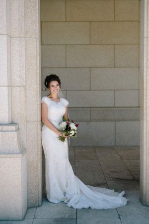 Hoopes Events | Chloe and Austin | Ben Lomond Suites | Ogden Utah | The Great Gatsby Wedding | Smiling Bride Leaning Against Pillar Chloe_Austin_Ben_Lomond_Suites_Ogden_Utah_Great_Gatsby_Smiling_Bride_Leaning_Against_Pillar.jpg