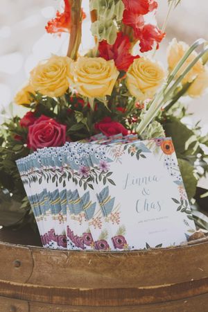 Programs on Wine Barrels with Vivid Yellow Roses Ceremony