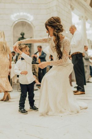 Bride dances with ring bearer at reception Reception