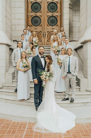 Wedding party stand outside on temple steps After Ceremony