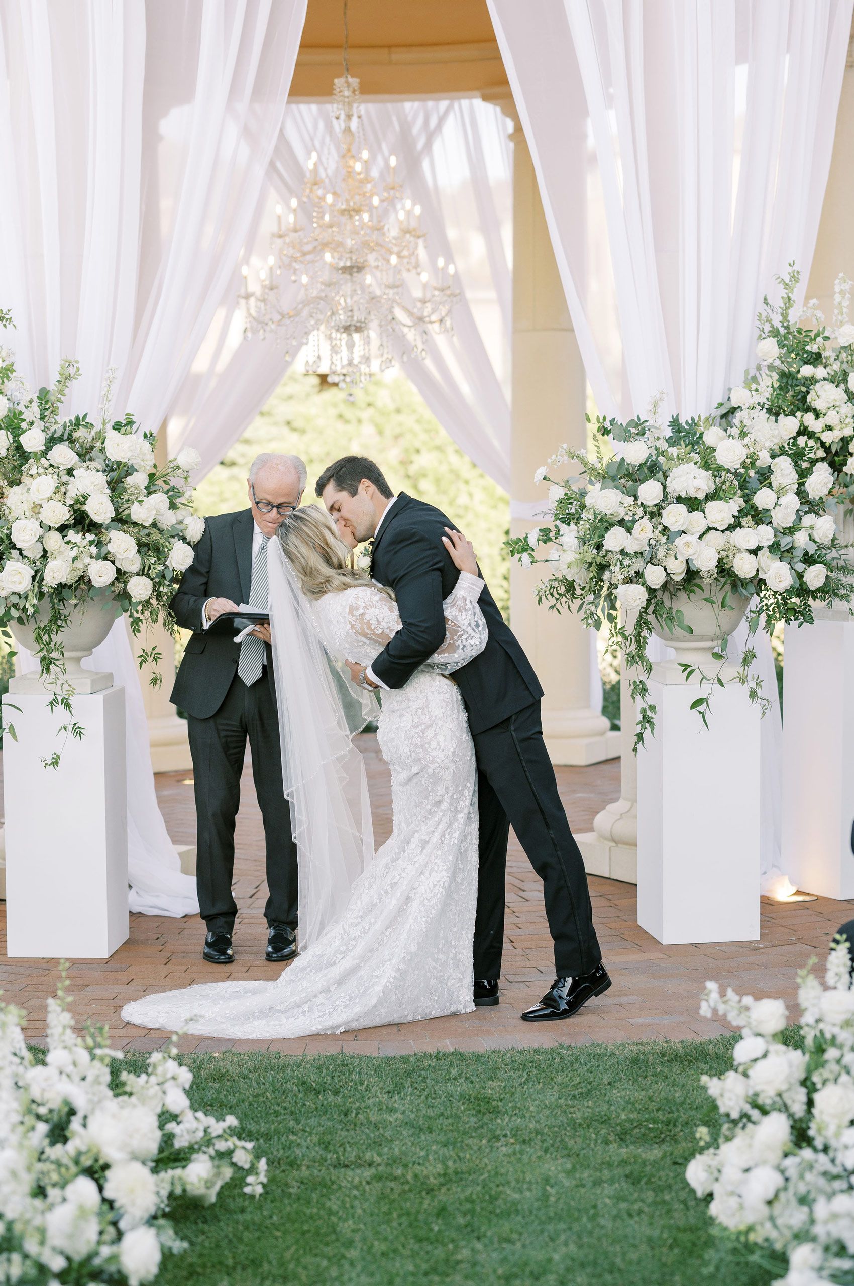 Couple Kissing Bride and Groom