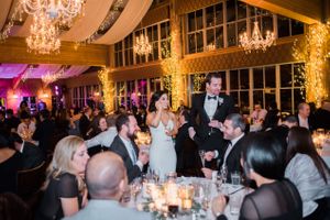 Hoopes Events | Julia and Mark | Silver Lake Lodge | Deer Valley | Park City Utah | Bride and Groom Greeting Guests Under Softly Lit Chandelier and Ceiling Julia_Mark_Silver_Lake_Lodge_Deer_Valley_Resort_Park_City_Utah_Bride_Groom_Greeting_Guests_Under_Softly_Lit_Chandelier_and_Ceiling.jpg