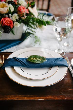 Hoopes Events | Rocky Mountain Bride | Winter Elopement | Deer Valley | Empire Lodge | Park City Utah | Silver-Rimmed Dishes with Blue Napkin and "Ashleigh" Leaf Rocky_Mountain_Bride_Winter_Elopement_Deer_Valley_Empire_Lodge_Deer_Valley_Resort_Park_City_Utah_Silver_Rimmed_Dish_Blue_Napkin.jpg