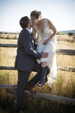 Hoopes Events | McCall and Brad | DeJoria Center | High Star Ranch | Kamas Utah | Bride and Groom Kissing on Fence McCall_Brad_High_Star_Ranch_Kamas_Utah_Bride_Groom_Kissing_Fence.jpg