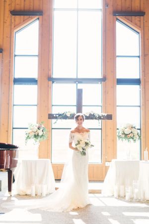 Bride in Front of Flower-Decked Cross Ceremony
