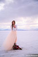 Salt_Air_Wedding_Shoot_Saltair_Resort_Salt_Lake_City_Utah_Bride_on_Salt_Flats_with_Bright_Floral_Bouquet.jpg