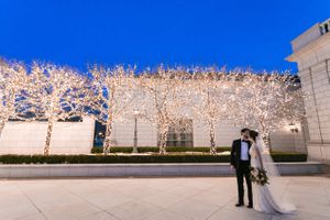 Stolen Kiss With Lighted Tree Background Pre-Ceremony