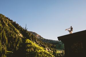 Dress Blowing in the Wind While Standing Atop Building Bride