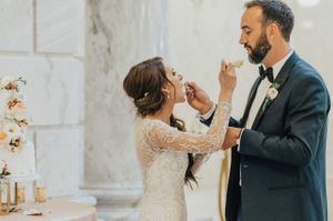 Bride and groom feed each other cake Reception - Cutting the Cake