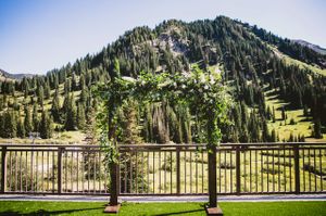 Floral-Decked Wedding Arch with Mountain Backdrop Details