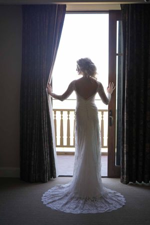 Stunning Bride Silhouetted in Wedding Dress Pre-Ceremony