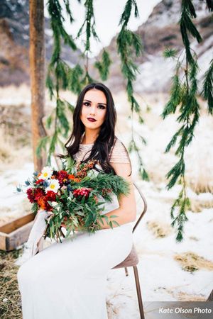 Hoopes Events | Romantic Winter-Styled Shoot | Bride Seated with and Evergreen Backdrop Romantic_Winter_Shoot_Seated_Bride_Evergreen_Backdrop.jpg