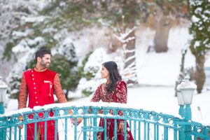 Indian Couple Holding Hands on Snow-Covered Bridge Pre-Ceremony