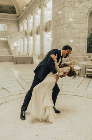 Groom dips the bride during first dance Reception