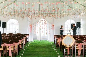 Hoopes Events | Katelyn and David | Park City Utah | Pink Carnation Ceiling with Pink Carnation Backdrop | Fruitwood Folding Chairs with Pink Sashes Katelyn_David_Park_City_Utah_Pink_Carnation_Ceiling.jpg