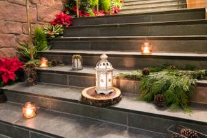 Glowing Lantern with Greenery on Stairs Rehearsal Dinner