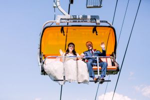 On the Orange Bubble Ski Lift Bride and Groom