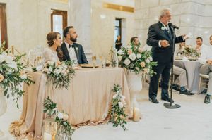 Bride and groom watch during father's toast Reception