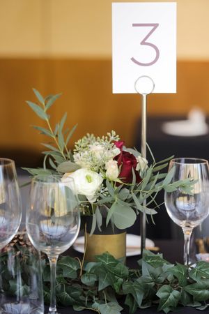 Hoopes Events | Tina and Dan | Snowbird Resort | Snowbird Utah | Centerpiece Accented by Green Garlands with White and Burgundy Roses Tina_Dan_Snowbird_Resort_Snowbird_Utah_Flower_Accented_Centerpiece.jpg