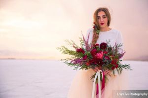 Hoopes Events | Saltair Wedding | Saltair Resort | Salt Lake City Utah | Styled | Bride With Red and Pink Bouquet | Sun Peeking Through Clouds Salt_Air_Wedding_Shoot_Saltair_Resort_Salt_Lake_City_Utah_Bride_with_Bouquet_Sun_Peeking_Through_Clouds.jpg