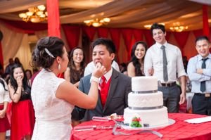 Bride Feeding the Groom After Cutting Cake Reception