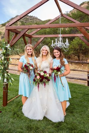 Hoopes Events | Tori and Sterling | Quiet Meadow Farms | Mapleton Utah | Bride and Bridesmaids in Front of Wood and Chandelier Backdrop Tori_Sterling_Quiet_Meadow_Farms_Mapleton_Utah_Bride_Bridesmaids_Chandelier_Backdrop.jpg