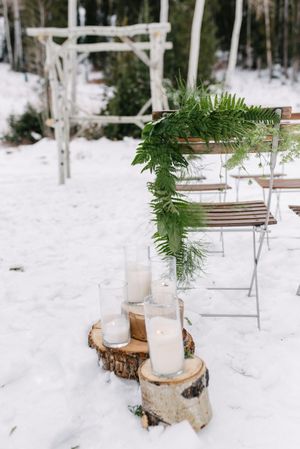 Hoopes Events | Rocky Mountain Bride | Winter Elopement | Deer Valley | Empire Lodge | Park City Utah | Ceremony Detail with Greenery and Glass Cylinder Candles Rocky_Mountain_Bride_Winter_Elopement_Deer_Valley_Empire_Lodge_Deer_Valley_Resort_Park_City_Utah_Ceremony_Detail_Tree_Stumps_Cylinder_Vase_Candles.jpg